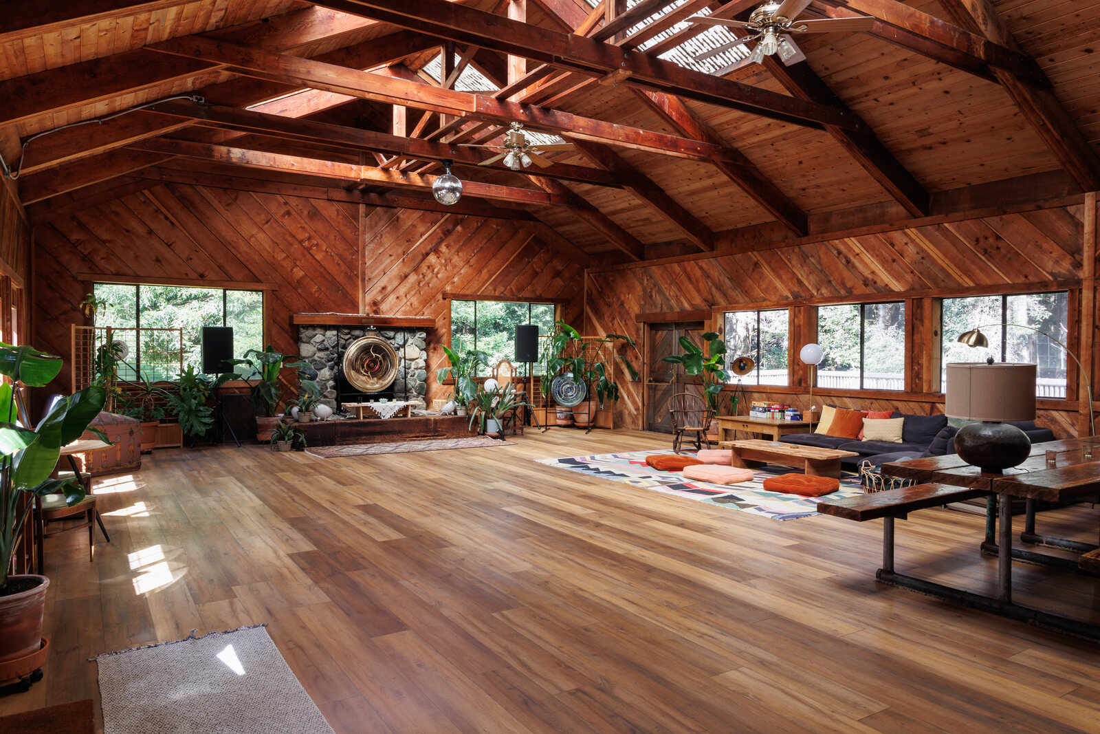 The lodge interior at Spirit Camp — cathedral wood beams, gong, and a great room for circles and movement.